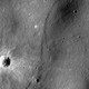A lobate scarp, a potential lunar fault line, bisects this image.